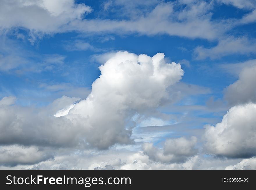 Blue sky with clouds and a single cloud in forefront. Blue sky with clouds and a single cloud in forefront.