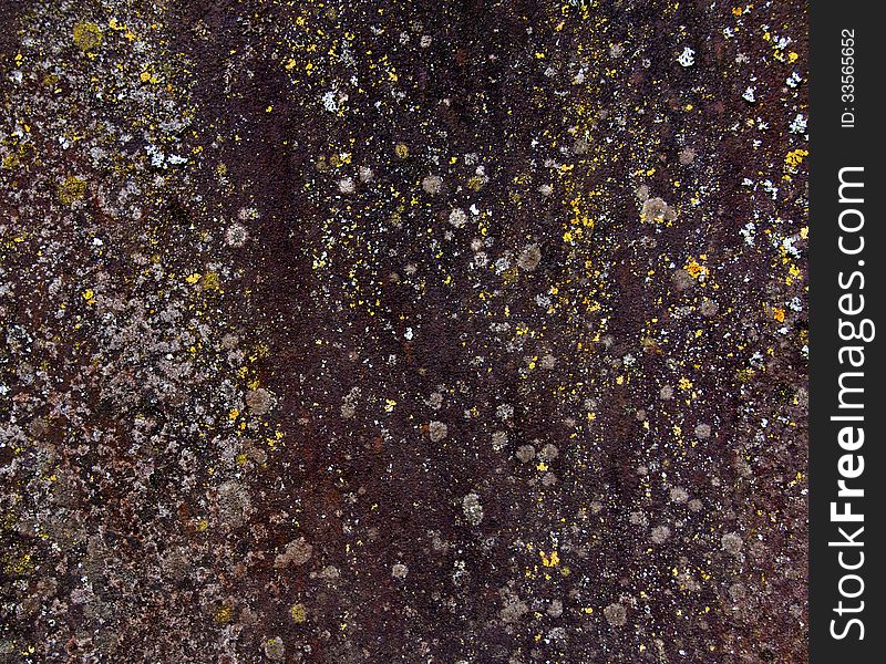 Texture of aged metal with brown, yellow and white speckles.