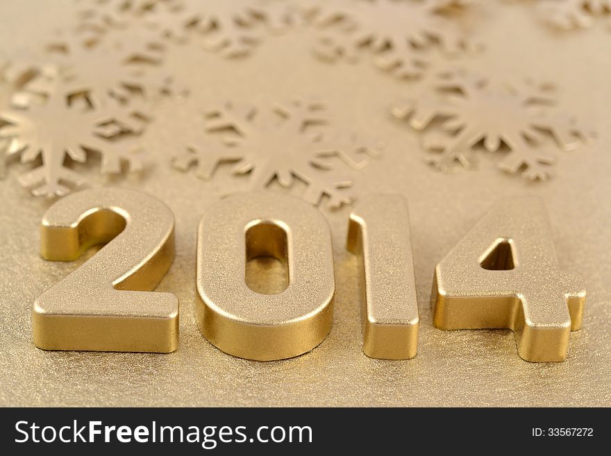 2014 year golden figures on the background of golden snowflakes