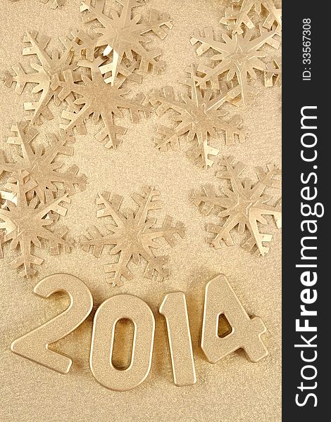 2014 year golden figures on the background of golden snowflakes