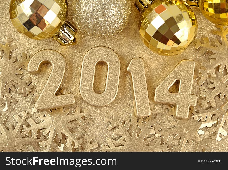 2014 year golden figures on the background of golden snowflakes