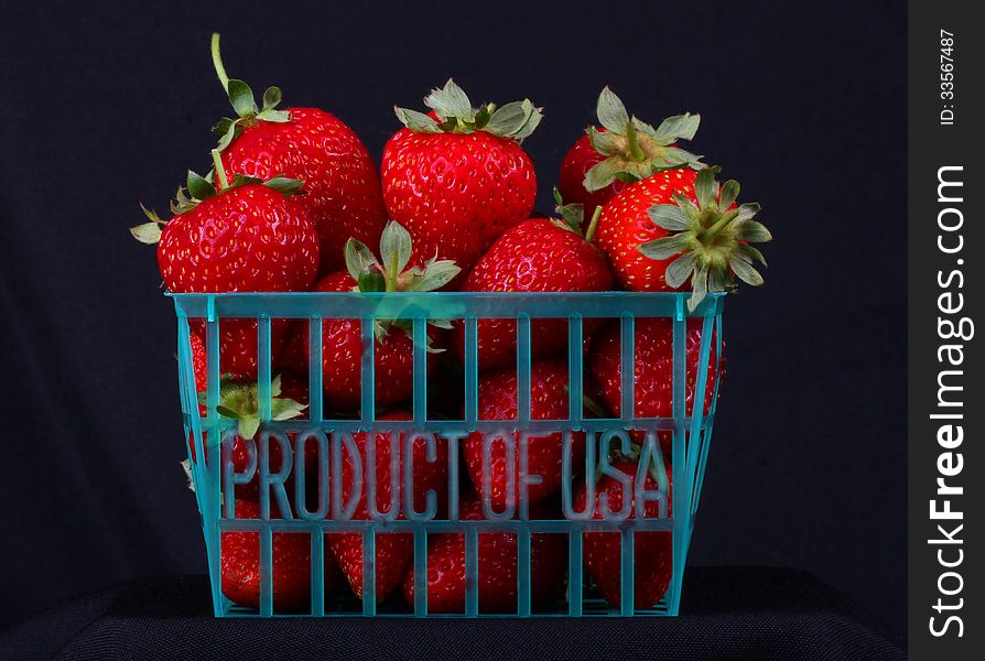 Produce basket of fresh strawberries with black background. Produce basket of fresh strawberries with black background