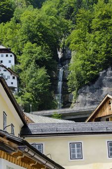 Waterfalls Betweens Traditional House In Hallstatt  Austria Stock Photos