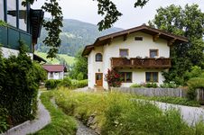 Traditional Wooden Houses With Water Stream Near Bybackground Of The Alps Royalty Free Stock Photos Traditional Wooden Houses With Water Stream Near Bybackground Of The Alps Royalty Free Stock Photos