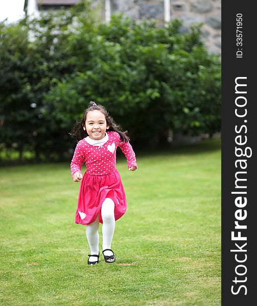 Happy Asian child running in the garden. Happy Asian child running in the garden.
