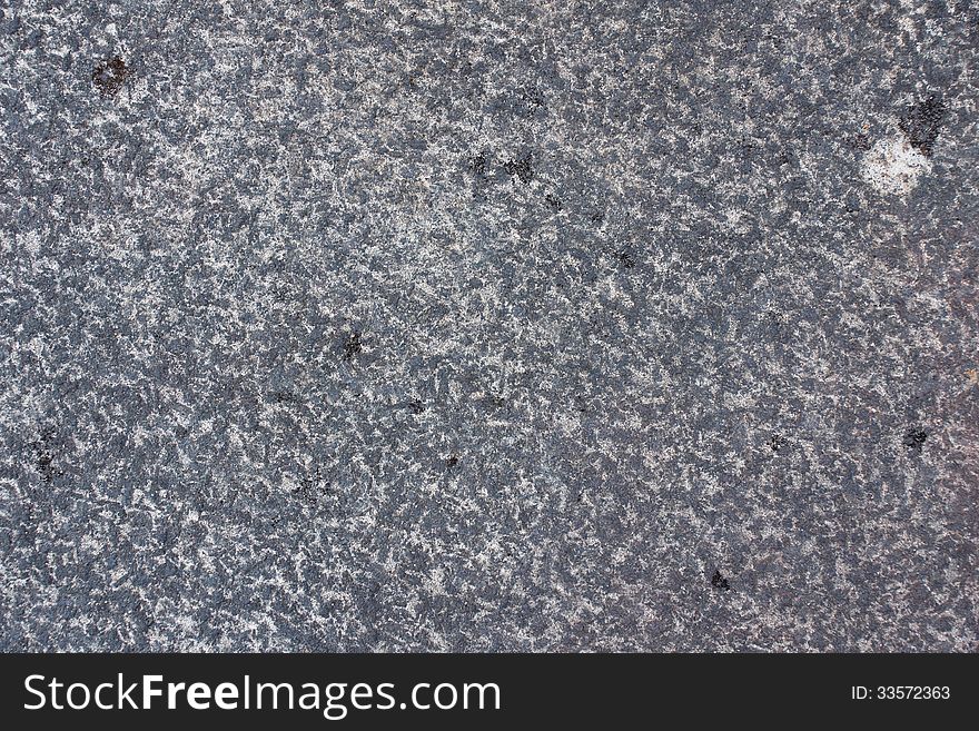 Surface of natural gray spotted stone as background. Surface of natural gray spotted stone as background