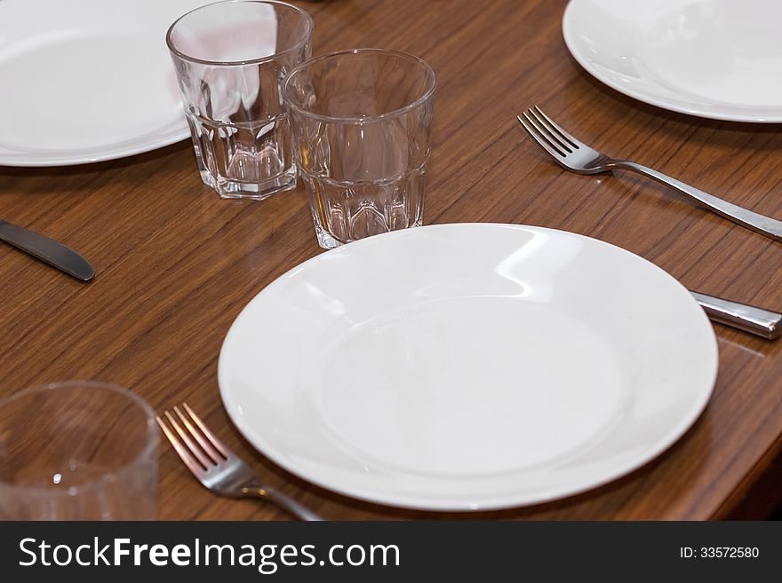 Dishes on table with glasses and silverware