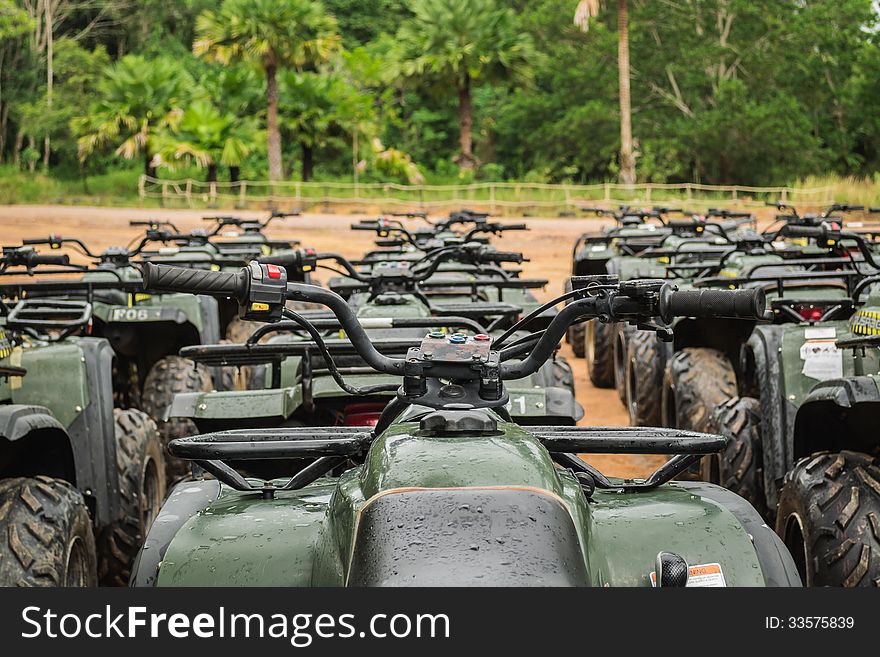 Sports quad bike or atv arranged in row after rain