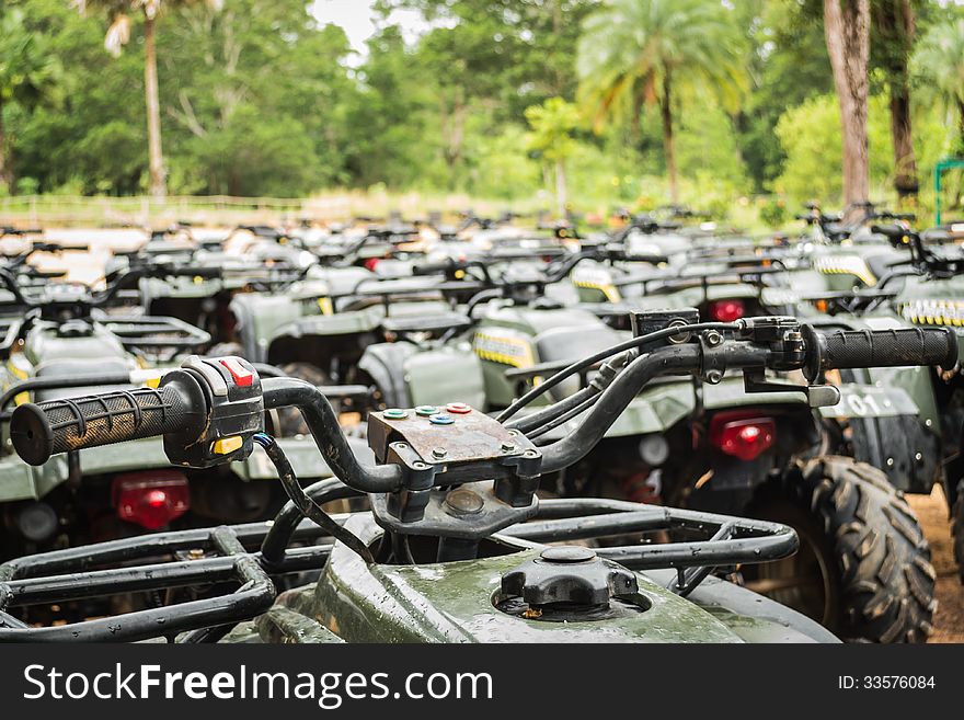 Sports quad bike or atv arranged in row after rain