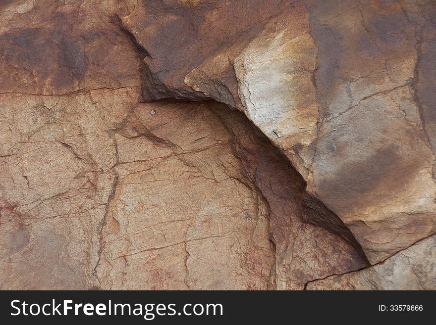 Surface of natural rust stone with cracks as background. Surface of natural rust stone with cracks as background