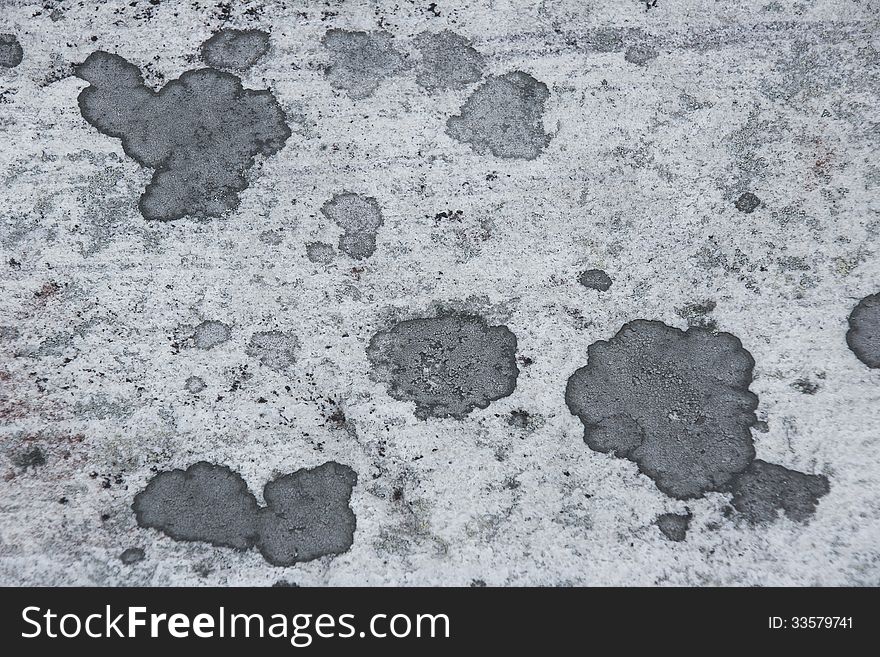 Surface of natural gray stone with spots as background. Surface of natural gray stone with spots as background