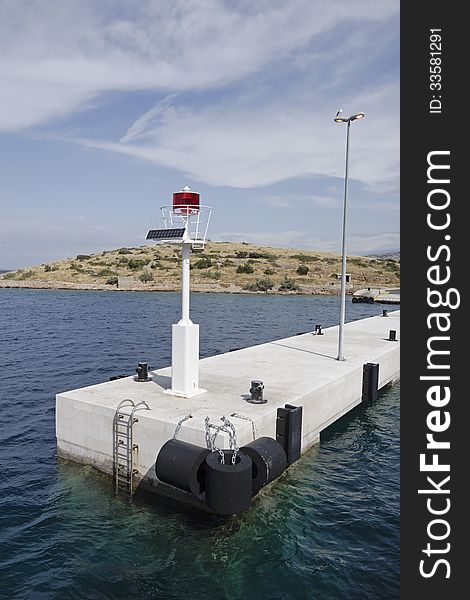 Beacon on solar energy on a white pier in Croatia