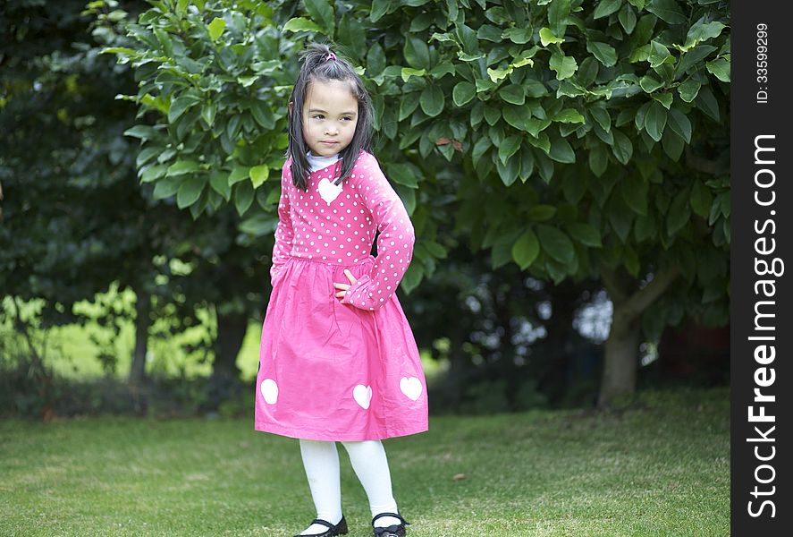 Enigmatic asian girl child in the garden. Enigmatic asian girl child in the garden.