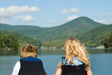 Boy And Girl Looking At Lake Royalty Free Stock Images