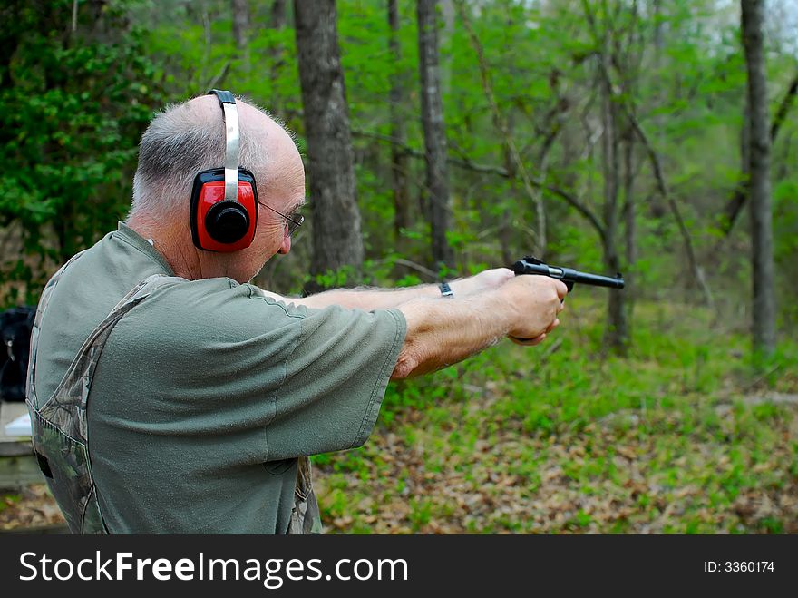 A hunter practicing his pistol marksmanship. A hunter practicing his pistol marksmanship.