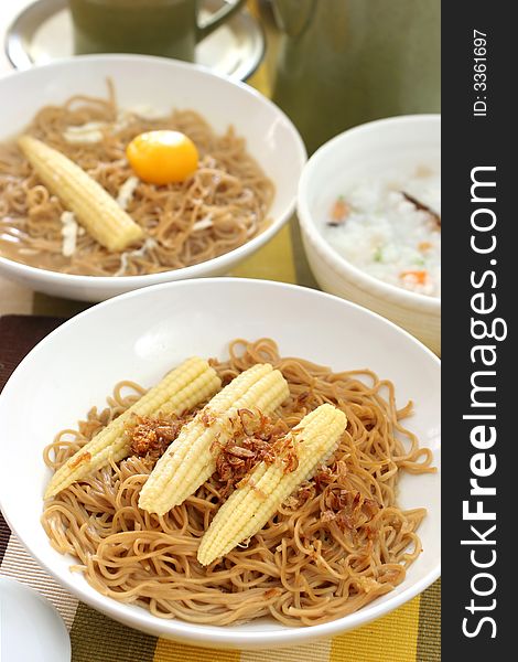 Brown Chinese buckwheat noodles with baby corn in light soup