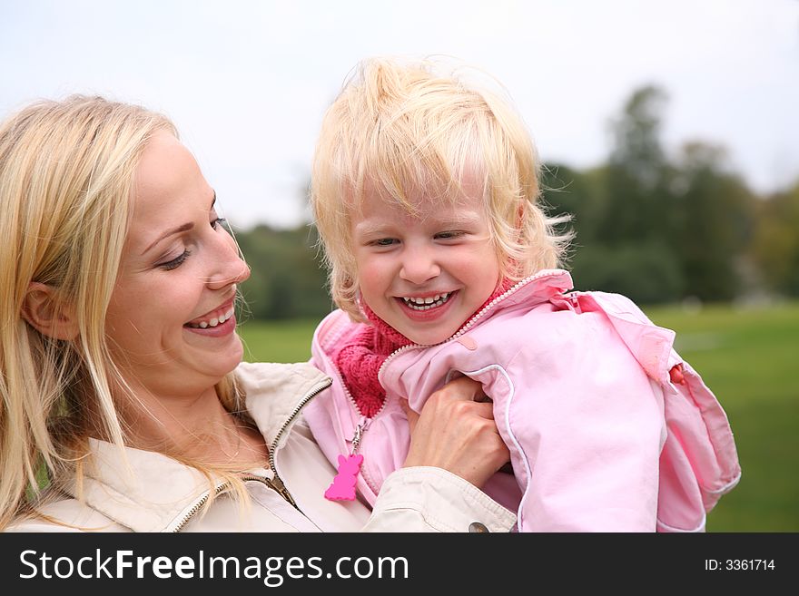 Mother holds daughter on the hands. Mother holds daughter on the hands