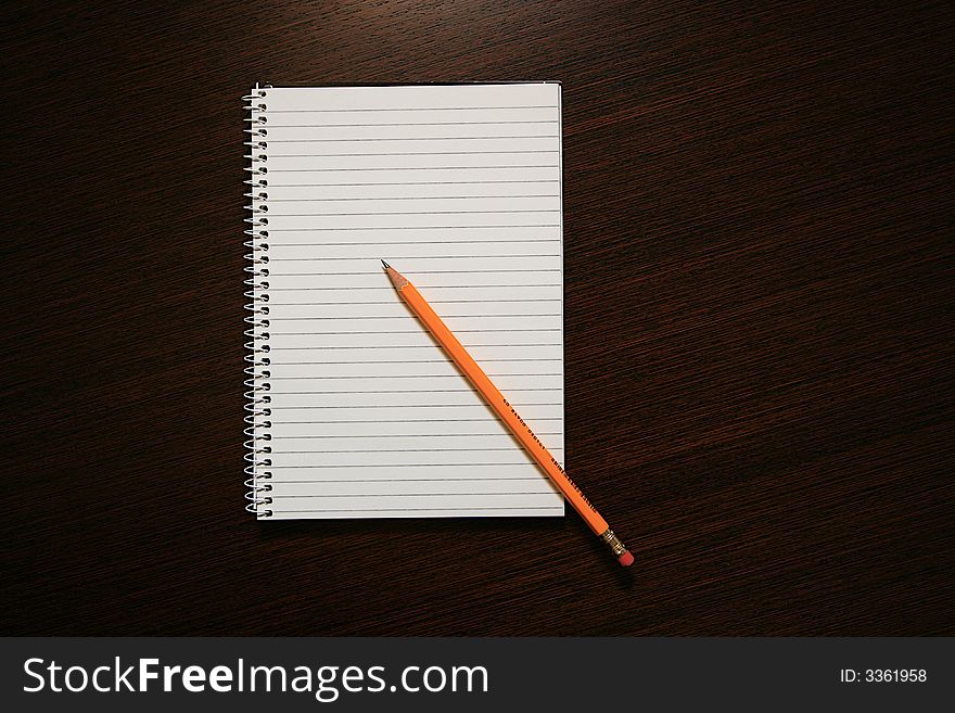 A Notebook and a Pencil on the Office Table