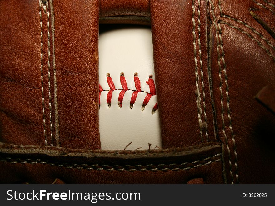 A close up of a Baseball in a glove