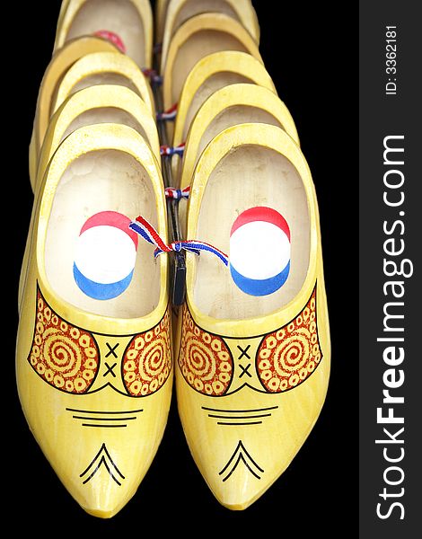 Painted wooden shoes from the Netherlands isolated on black