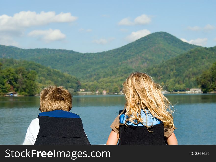 Boy And Girl Looking At Lake