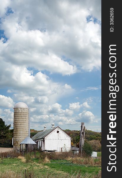 Old barn and silo under a cloudy sky. Old barn and silo under a cloudy sky.