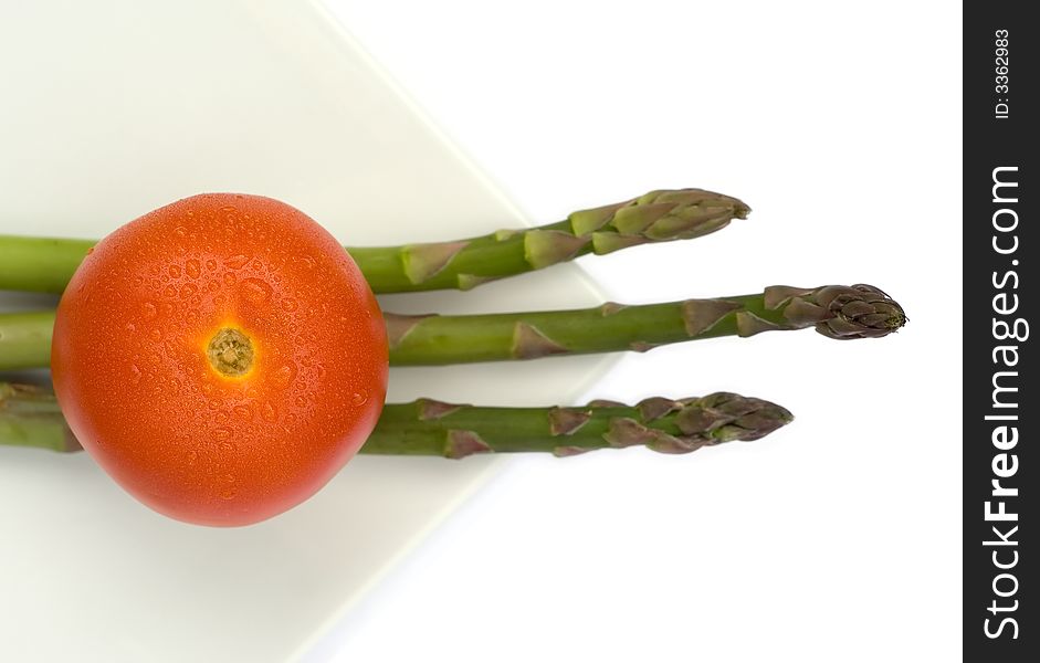 Tomato and asparagus in a white square plate
