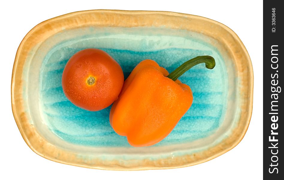 Tomato and capsicum on a oval shelling plate. Tomato and capsicum on a oval shelling plate