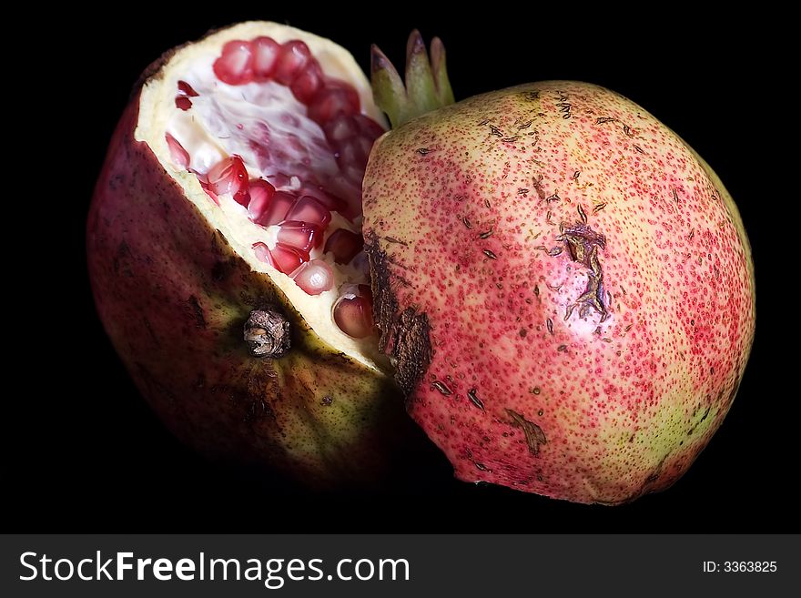 Pomegranate isolated on black background.