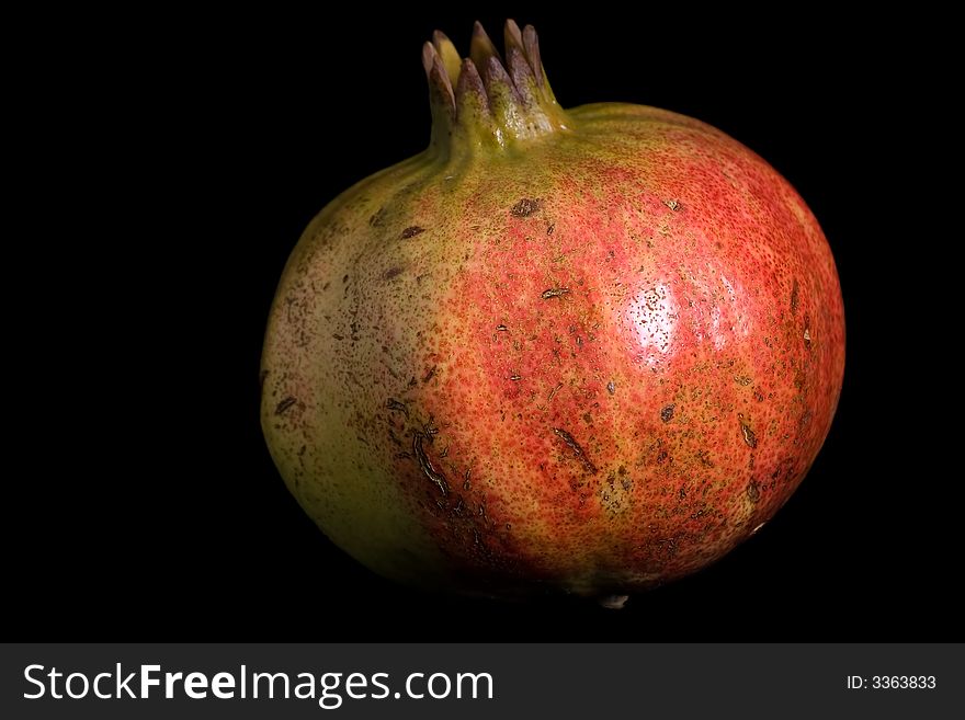 Pomegranate isolated on black background.