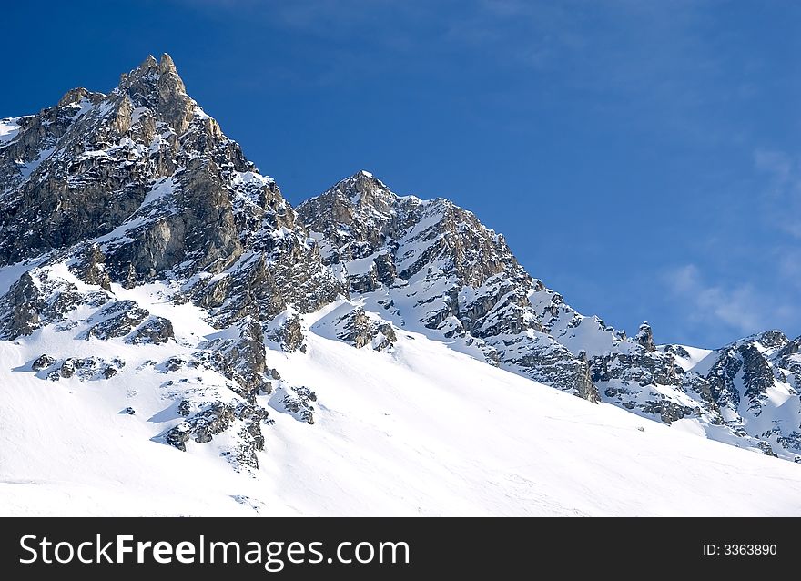 Snowed mountainrange with visible rocks. Snowed mountainrange with visible rocks