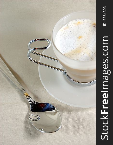 Cup of cappuccino with spoon. Cup of cappuccino with spoon