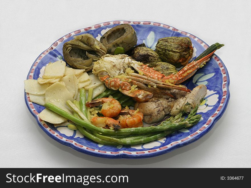Sea and meat food with vegetables on plate. Sea and meat food with vegetables on plate