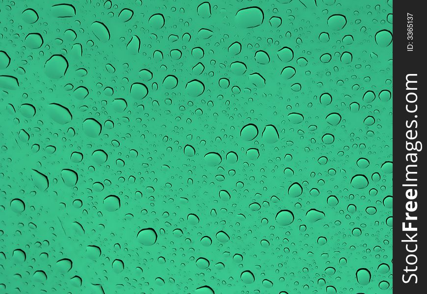 Abstract background with drops of water in a green glass. Abstract background with drops of water in a green glass