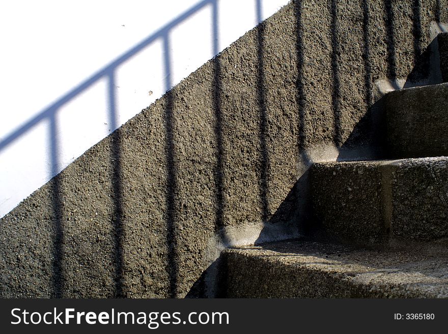 Background with granite wall and stairs and shadow in a white wall