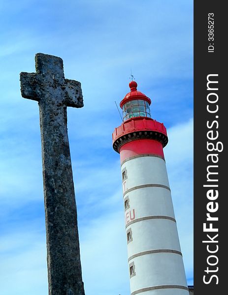 Lighthouse and ancient Celtic cross on the coast of Brittany. Lighthouse and ancient Celtic cross on the coast of Brittany