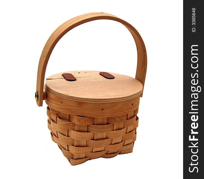 An isolated woven wooden basket with a lid, useful for a picnic. An isolated woven wooden basket with a lid, useful for a picnic.