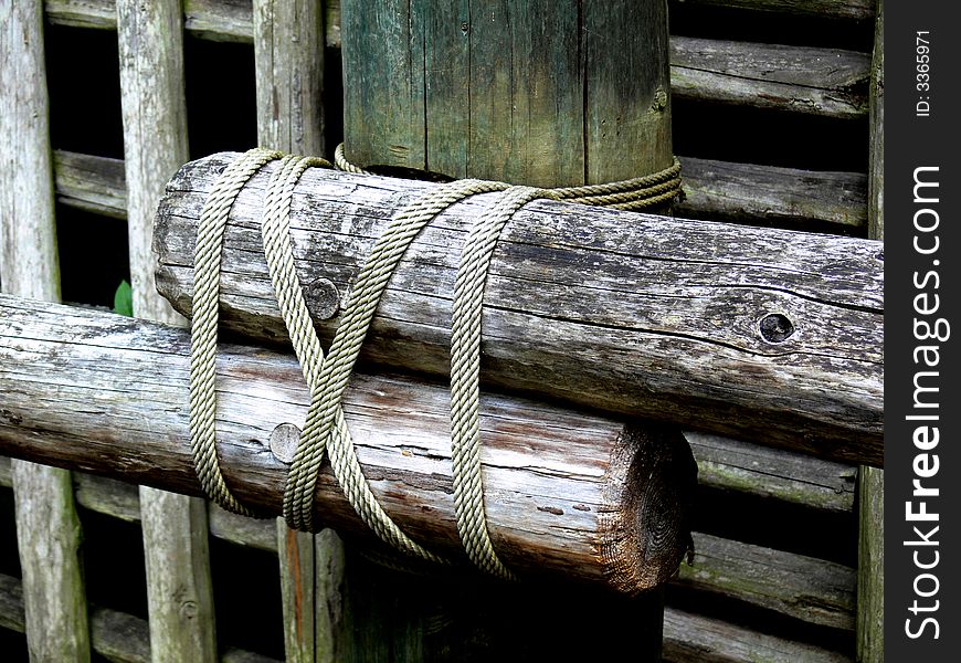 A shot of a log type fence that is tied together with rope. A shot of a log type fence that is tied together with rope.