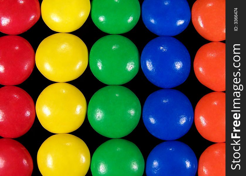 Close up of colorful chocolate candies with each color in a row. Close up of colorful chocolate candies with each color in a row.