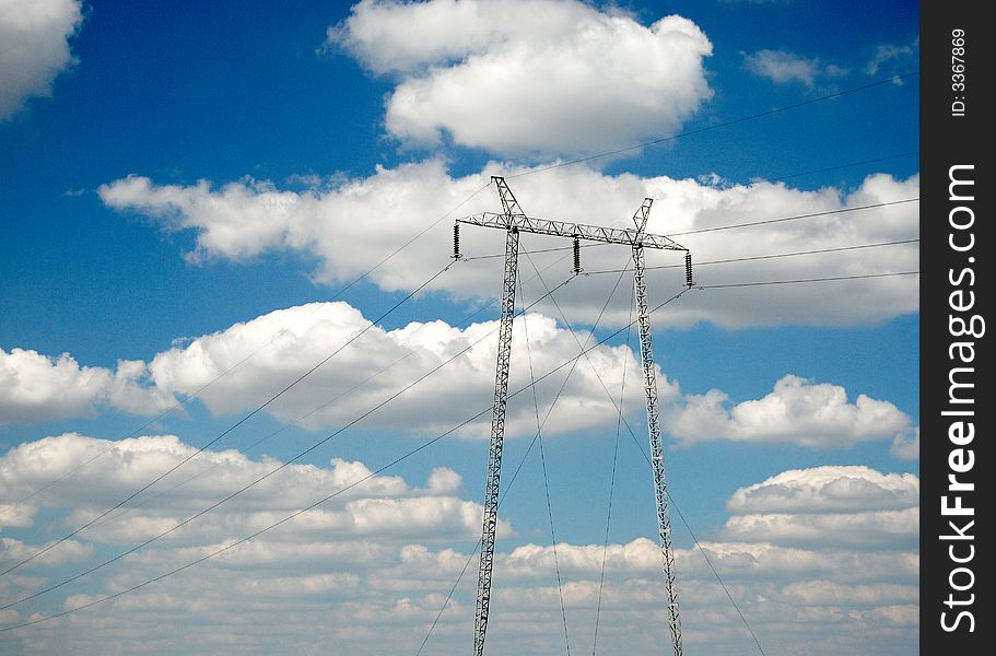 High voltage electricity pylon over blue sky and white clouds. High voltage electricity pylon over blue sky and white clouds