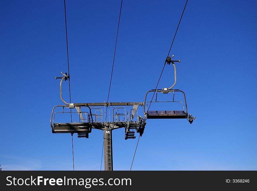 Chairs in a ski lift ,and blue sky