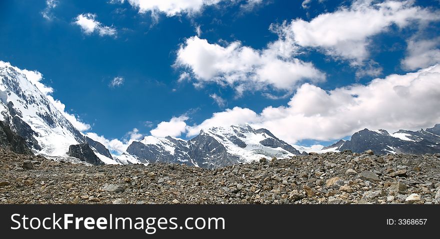 Landscape with high mountains, snowy peaks and blue sky. panoramic. Landscape with high mountains, snowy peaks and blue sky. panoramic