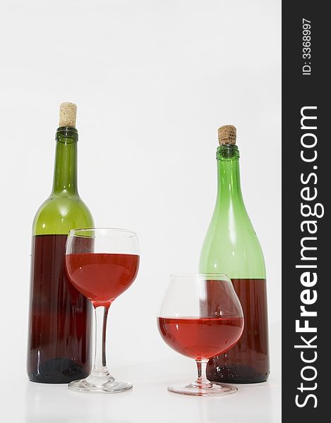 Red wine bottles and glasses isolated over white. Red wine bottles and glasses isolated over white