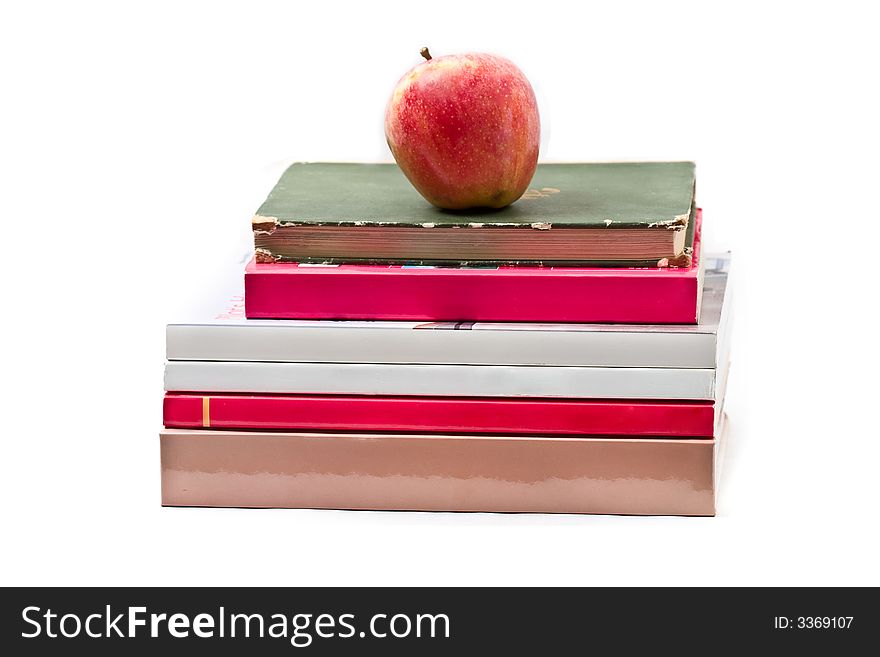 Fresh red apple on stack of books - isolated on white. Fresh red apple on stack of books - isolated on white