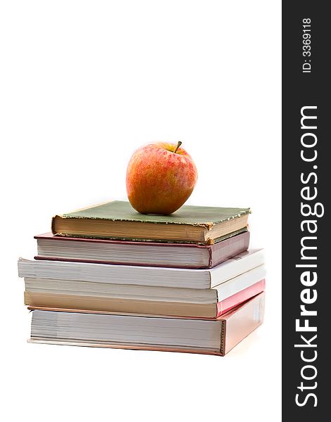Fresh red apple on stack of books - isolated on white. Fresh red apple on stack of books - isolated on white