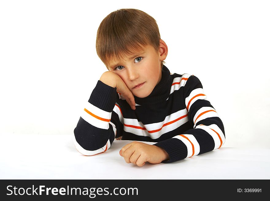 The boy in a striped golf on a white background