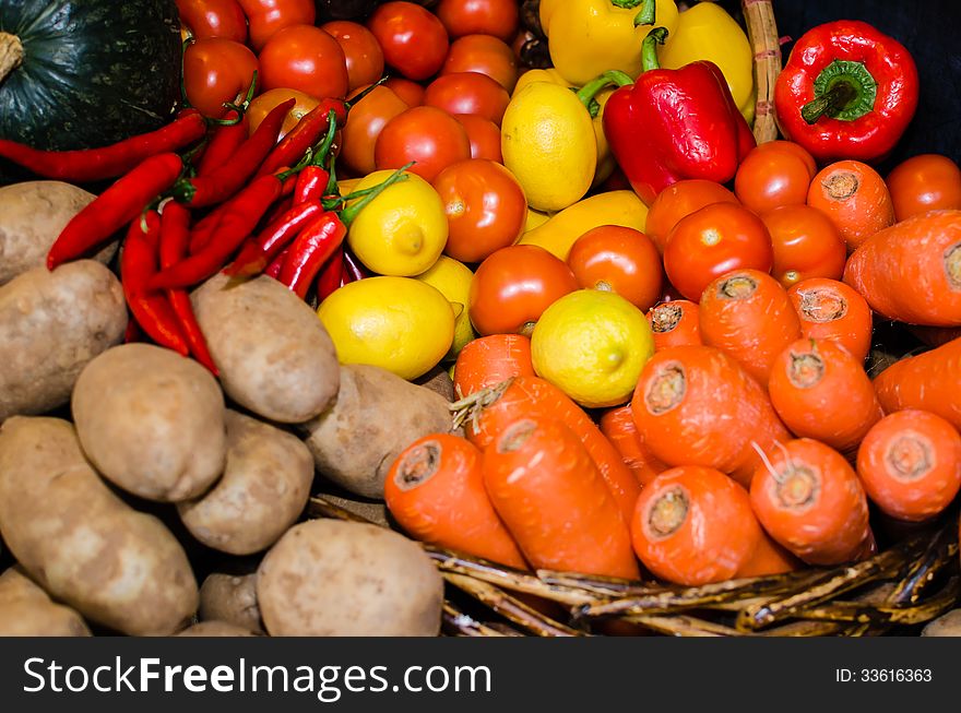 Vegetables in market such as carrot, potato, chili and lemon