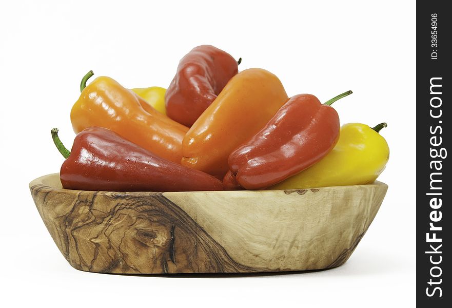 Red, Orange, and Yellow Peppers in Wood Bowl