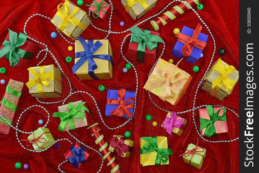 Red background with Christmas gifts and decorations. Red background with Christmas gifts and decorations