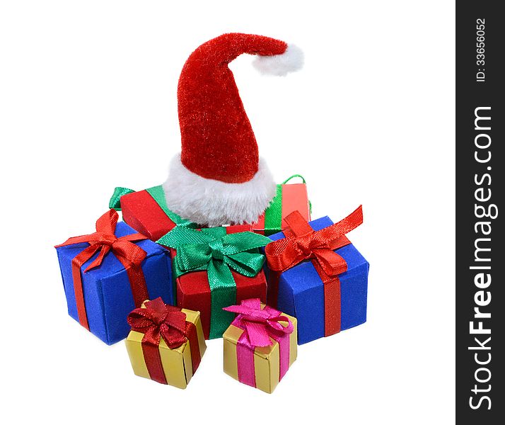 Isolated heap of colorful gift boxes and Santas red hat on top. Isolated heap of colorful gift boxes and Santas red hat on top